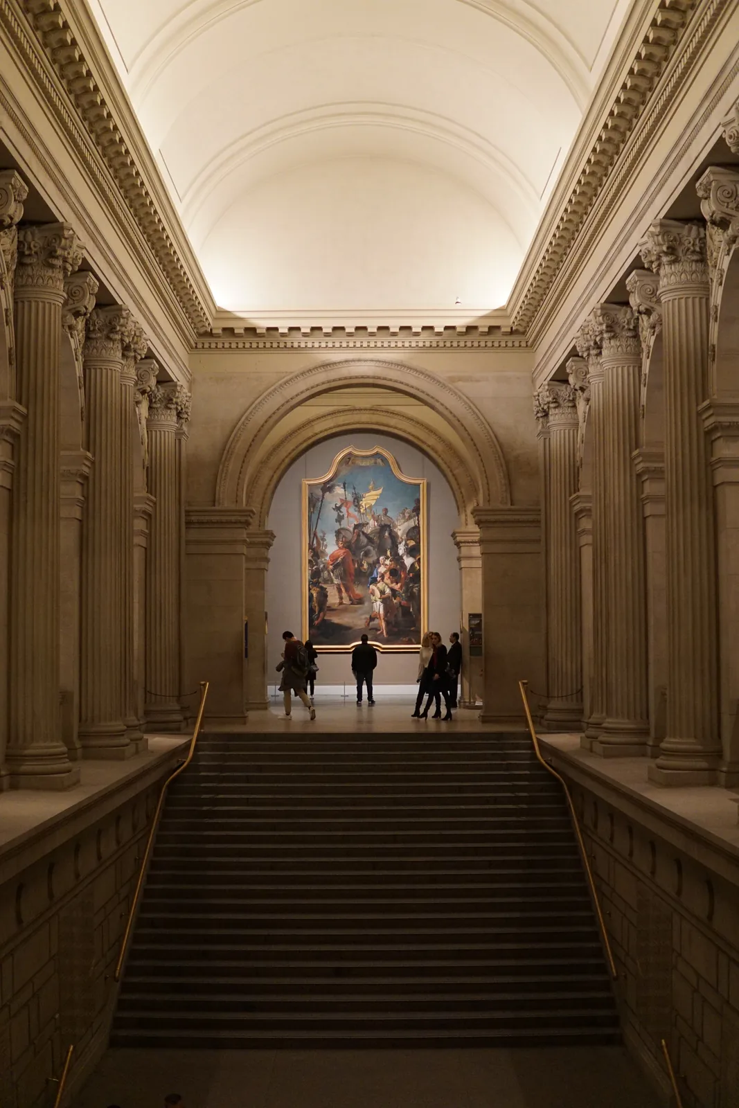 The Metropolitan Museum of Art's Great Hall staircase, with a large painting at the top